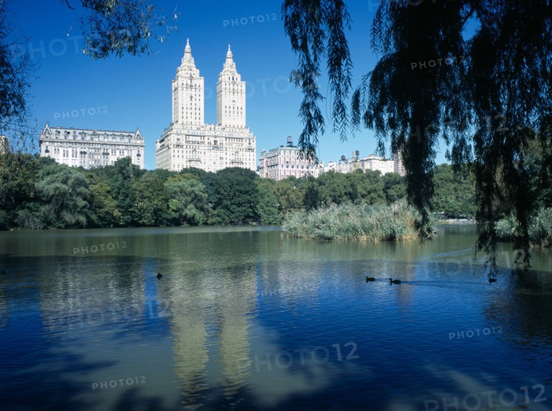 New York City, New York, USA. Central Park. View over The Lake toward city architecture on the western edge American Blue Destination Destinations North America Northern United States of America