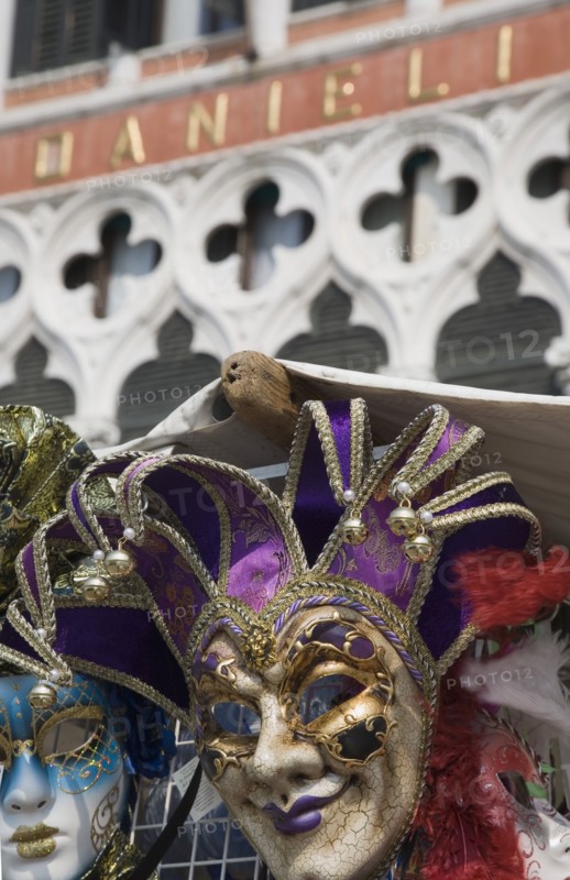 Venice, Veneto, Italy. Carnival masks in front of partly seen facade of Hotel Danieli. Italy Italia Italian Venice Veneto Venezia Europe European City Hotel Danieli Facade Architecture Carnival Festival Mask Masks Destination Destinations Southern Europe