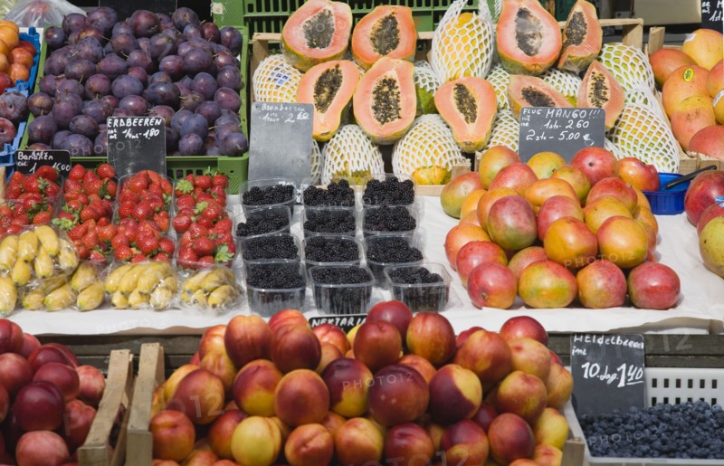 Vienna, Austria. Display of fresh fruit for sale on market stall including plums strawberries papaya mango and nectarines. Austria Austrian Republic Vienna Viennese Wien Europe European City Capital Naschmarkt Market Display Fresh Food Fruit Stall Shop Store Destination Destinations Osterreich Viena Western Europe