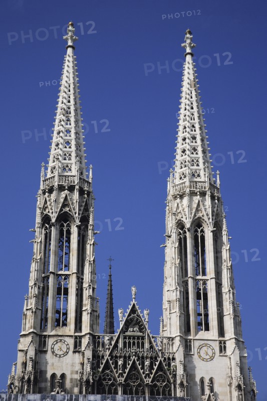 Vienna, Austria. Alsergrund Ringstrasse Votifkirche neo-gothic Votive Church exterior with twin spires. Austria Austrian Vienna Wien Viennese Republic Austro-Bavarian Wean Europe European City Capital Travel Destination Alsergrund Ringstrasse Votifkirche Votive Church Architecture Belltowers Religion Religious Blue Sky Destination Destinations Osterreich Viena Western Europe
