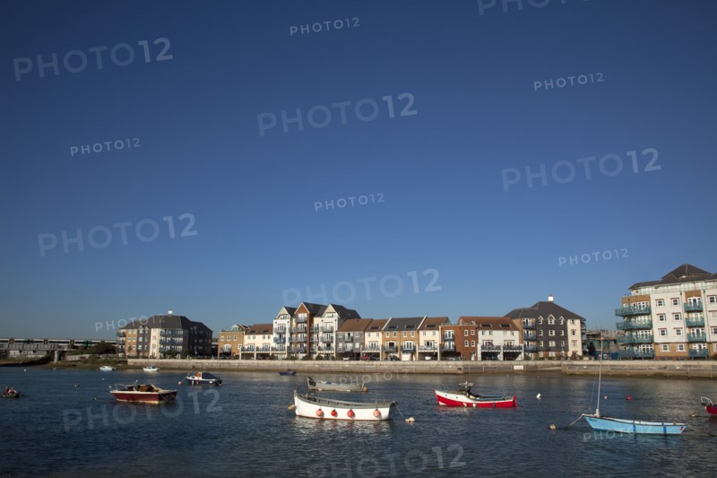 Shoreham-by-Sea, West Sussex, England. Ropetackle riverside housing developement on former industrial site. England English UK United Kingdom GB Great Britain British Europe European West Sussex County Shoreham Shoreham-by-Sea by Sea River Arun Water Waterside Modern Apartment Apartments Flat Flats Architecture Ropetackle Brown Field Development Site Boat Boats Blue Sky