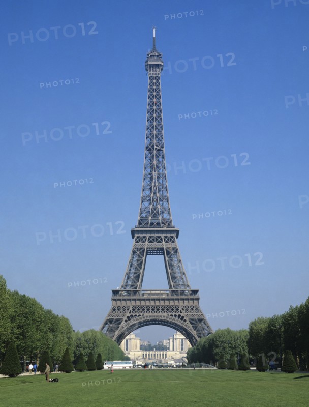 Paris, Ile de France, France. Eiffel Tower from the Parc du Champs de Mars. France French Europe European Ile de France Paris Parisian Eiffel Tower Steel Parc Park Champs de Mars Blue Sky Destination Destinations Western Europe