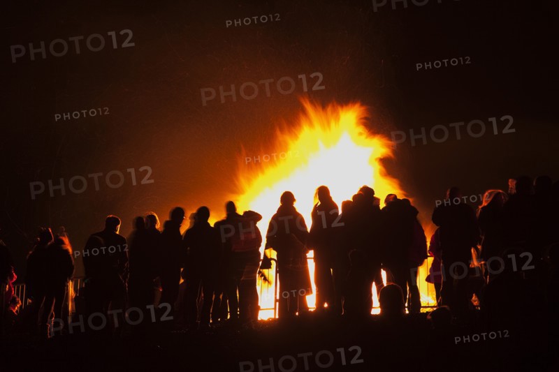 Shoreham Beach, West Sussex, England. Festivals Guy Fawkes Bonfire People silhouetted by flames from fire on the beach. Festival Festivals Bonfire Night Guy Fawkes Flame Flames People Group Crowd Revellers Silhouette Silhouetted Fire Orange Yellow Black