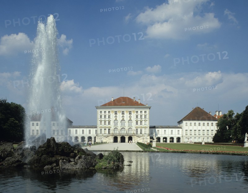 Munich, Bavaria, Germany. Nymphenburg Palace and Garden. Germany German Europe European Bavaria Bavarian Munich Muenchen Nymphenburg Palace Gardens Fountain Building Architecture Exterior. Stately Water Tourists Bayern Blue Clouds Cloud Sky Destination Destinations Deutschland Garden Plants Flora Gardens Plants History Historic Holidaymakers MŸnchen Tourism Western Europe