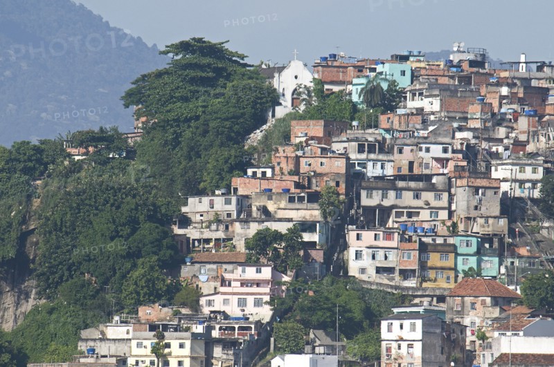 Rio de Janeiro, Brazil. Favela or slum housing above Saude neighbourhood some with traditional tile roofs very steep hill roads greenery and Church. Brazil Brasil Brazilian Brasilian South America Latin Latino American City Urban Architecture Houses Housing Homes Favela Slum Slums Saude Neighborhood Neighbourhood Favelas Classic Classical Destination Destinations Historical Latin America Older Shanty South America Southern
