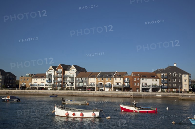Shoreham-by-Sea, West Sussex, England. Ropetackle riverside housing developement on former industrial site. England English UK United Kingdom GB Great Britain British Europe European West Sussex County Shoreham Shoreham-by-Sea by Sea River Arun Water Waterside Modern Apartment Apartments Flat Flats Architecture Ropetackle Brown Field Development Site Boat Boats Blue Sky