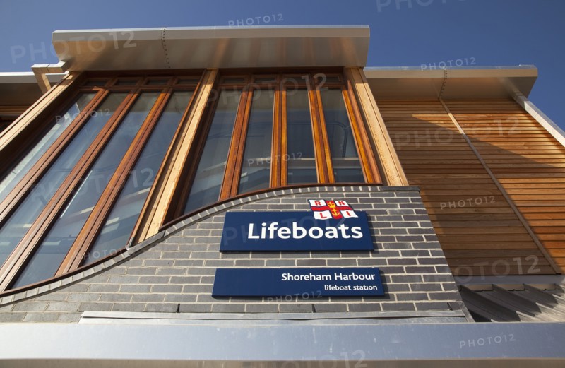 Shoreham-by-Sea, West Sussex, England. Kingston Beach Newly constructed lifeboat house opposite the harbour entrance. England English West Sussex County Shoreham Shoreham-by-Sea by Sea Water Kingston Beach Europe European Architecture Modern Life Boat Lifeboat Lifeboats RNLI Wood Wooden Clad Galvanised Metal Zinc Blue Sky Station Home Timber Frame