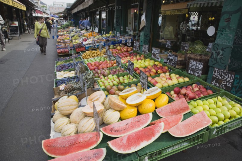 Vienna, Austria. The Naschmarkt. Display of fresh fruit for sale on stall outside shopfront including apples melon and pineapple. Austria Austrian Republic Vienna Viennese Wien Europe European City Capital Naschmarkt Market Display Fresh Food Fruit Vegetables Veg Vegetable Stall Shop Store Destination Destinations Osterreich Viena Western Europe
