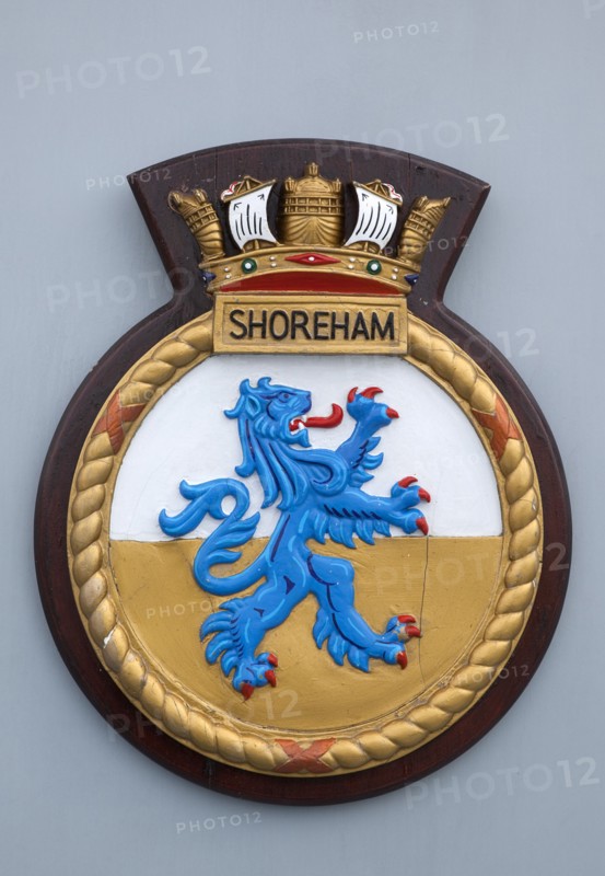 HMS Shoreham emblem on board the mine sweeper. Sign Signs Emblem Coat Arms Military Naval Royal Navy British HMS Shoreham Badge Allegory Symbol Griffin