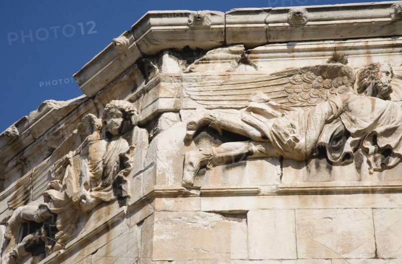 Athens, Attica, Greece. Tower of the Winds. Part view of octagonal Pentelic marble Roman clocktower on the Agora with detail of carved frieze depicting the gods of the winds. Greece Greek Attica Athens Europe European Vacation Holiday Holidays Travel Destination Tourism Ellas Hellenic Agora Pentelic Roman Marble Stone Clocktower Architecture Frieze Atenas Athenes Destination Destinations Ellada History Historic Southern Europe
