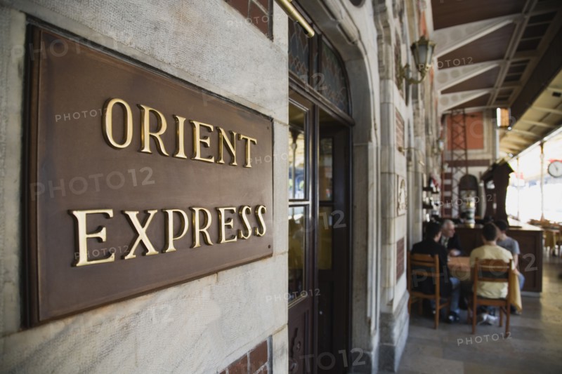 Istanbul, Turkey. Sultanahmet. Orient Express sign beside cafe on station platform. Istanbul Sirkeci Terminal or Sirkeci is a terminus main station of the Turkish State Railways or TCDD in Sirkeci on the European part of Istanbul. International domestic and regional trains running westwards depart from this station which was inaugurated as the terminus of the Orient Express. Turkey Turkish Istanbul Constantinople Stamboul Stambul City Europe European Asia Asian East West Urban Destination Travel Tourism Transportt Rail Railway Train Trains Station Platform Orient Express Orient Express Sirkeci TCCD Bar Bistro Destination Destinations Middle East Restaurant Signs Display Posted Signage South Eastern Europe Turkiye Western Asia