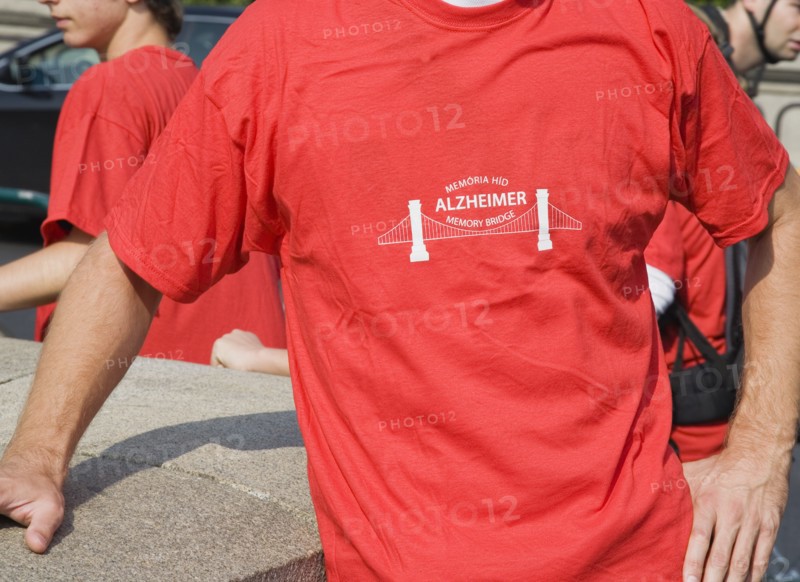 Budapest, Pest County, Hungary. Cropped view of participant in charity walk in aid of Alzheimers disease victims at Memory Bridge also known as the Chain Bridge. Hungary Hungarian Europe European East Eastern Buda Pest Budapest City T-Shirts Red Walker Walk Charity Alzheimers Bridge Memory Chain Color Eastern Europe