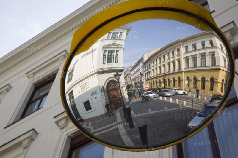 Budapest, Pest County, Hungary. Circular traffic guiding mirror reflecting apartments on River Danube bank in Pest. Hungary Hungarian Europe European East Eastern Buda Pest Budapest City Architecture Details Exterior Facade Convex Safety Mirror Reflect Refelcting Reflected Image Street View Destination Destinations Eastern Europe