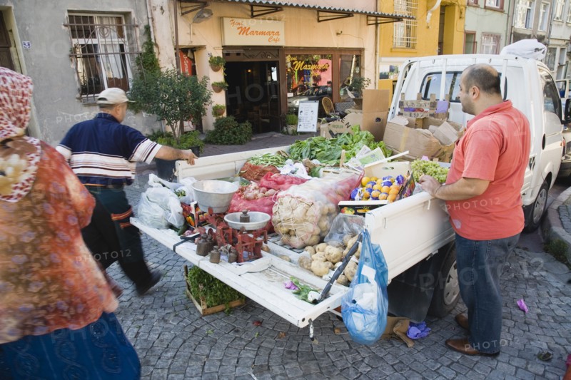 Istanbul, Turkey. Sultanahmet. Fresh fruit and vegetable produce arrives by truck for local shoppers. Set of scales on tail gate with sacks of potatoes and boxes of oranges in the back. Turkey Turkish Istanbul Constantinople Stamboul Stambul City Europe European Asia Asian East West Urban Destination Sultanahmet Market Markets Stall Vegetable Vegetables Food Produce Vendor Selling Truck Van Scales Destination Destinations Lorry Middle East South Eastern Europe Turkiye Western Asia