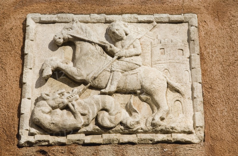 Venice, Veneto, Italy. Centro Storico Wall plaque on Venetian facade with relief carving depicting St George killing the Dragon. Italy Italia Italian Venice Veneto Venezia Europe European City Centro Storico Architecture Facade Wall Plaque Relief St Saint George Dragon Slayer Slaying Destination Destinations Southern Europe