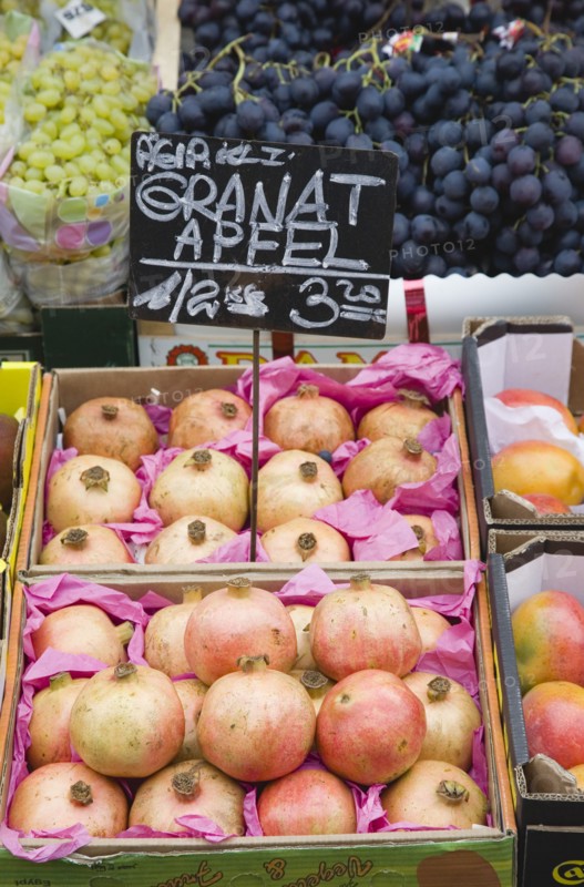 Vienna, Austria. The Naschmarkt. Display of fresh fruit for sale on market stall with grapes and pomegranates. Austria Austrian Republic Vienna Viennese Wien Europe European City Capital Naschmarkt Market Display Fresh Food Fruit Vegetables Veg Vegetable Stall Shop Store Destination Destinations Osterreich Viena Western Europe