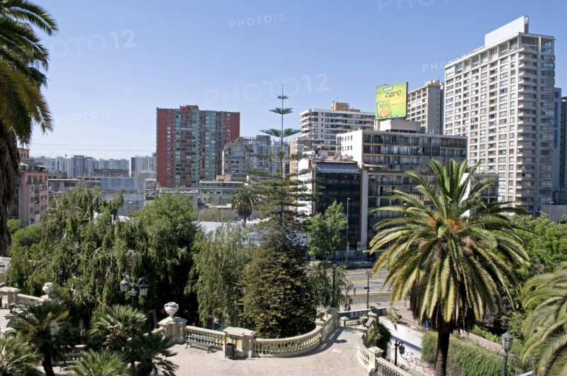 Santiago, Chile. Highrise modern apartment blocks in downtown from the Cerro Santa Lucia with sweeping classical balustrade and Chilean Palm tree in the foreground. Chile Chilean South America American Hispanic Santiago City Cityscape Urban Highrise Apartment Apartments Block Blocks Towers Flats Cerro Santa Lucia Palm Tree Trees Caribbean Destination Destinations Flat Latin America Latino South America Southern Windward Islands