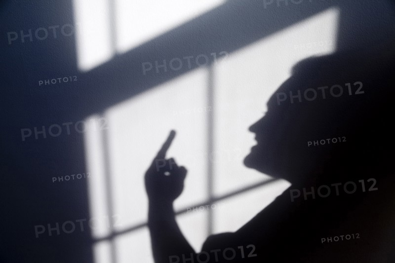 Shadow of a person giving a hand gesture Flipping the Bird. Anger Angry Annoyed Day Daytime Gesture Gesturing Hand Raised Head And Shoulders Headshot Horizontal Implied People Implied Person Indoors Inside Irritated One Person People Person Profile Shadow Shadows Sunlight Sunny Sunshine Unrecognisable People Unrecognizable Person bird curse disagree disagreement expletive express expression finger flip flipping off hand gesture opinion 1 One individual Solo Lone Solitary Single unitary