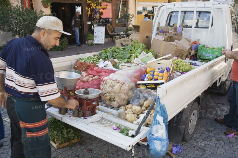 Istanbul, Turkey. Sultanahmet. Fresh produce arrives by truck for local shoppers with set of scales on the open tail gate and back filled with sacks of potatoes boxes of oranges apples grapes and lettuce. Turkey Turkish Istanbul Constantinople Stamboul Stambul City Europe European Asia Asian East West Urban Destination Travel Tourism Sultanahmet Market Stall Stall Vegetable Vegetables Food Produce Vendor Selling Truck Van Scales Destination Destinations Lorry Middle East South Eastern Europe Turkiye Western Asia