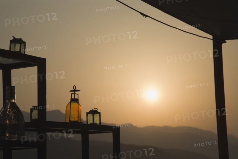 Samos, Northern Aegean, Greece. Vathy. Sun setting behind open air bar with the Ampelos massif beyond. Greece Greek Europe European Vacation Holiday Holidays Travel Destination Tourism Ellas Hellenic Aegean Aegean Samos Island Sea Water Ampelos Massif Bar Drinks Bottles Sun Silhouette Silhouette Silhouetted Destination Destinations Ellada Scenic Solid Outline Shade Silhouette Solid Outline Shade Silhouetted Southern Europe Sundown Atmospheric Water