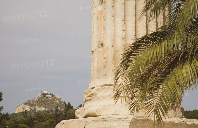 Athens, Attica, Greece. The Temple of Olympian Zeus column base of ruined temple dedicated to king of the Olympian gods Zeus with Mount Lycabettus rising behind. Greece Greek Attica Athens Europe European Vacation Holiday Holidays Travel Destination Tourism Ellas Hellenic Acropolis Parthenon Temple Olympian Zeus Ruin Ruins Column Columns Atenas Athenes Destination Destinations Ellada History Historic Southern Europe