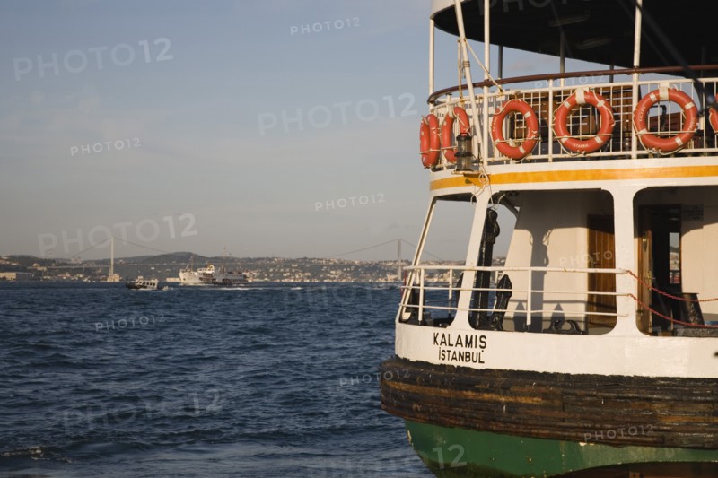 Istanbul, Turkey. Sultanahmet. Ferry flying Turkish flag on the Bosphorous with bridge behind. Since March 2006 Istanbuls traditional commuter ferries have been operated by Istanbul Sea Buses. Turkey Turkish Istanbul Constantinople Stamboul Stambul City Europe European Asia Asian East West Urban Sultanahmet Bosphorous Destination Travel Tourism Transport Water Ship Boat Ferry Commuter Cummuters Classic Classical Destination Destinations Historical Middle East Older South Eastern Europe Turkiye Water Western Asia