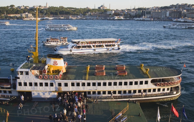 Istanbul, Turkey. Sultanahmet. People boarding Bosphorous passenger ferry at sunset with Hagia Sophia behind. Turkey Turkish Istanbul Constantinople Stamboul Stambul City Europe European Asia Asian East West Urban Destination Travel Tourism Sultanahmet Bosphorous Passenger Passengers Ferry Boat Ship Transport Water Sea Commute Commuters Hagia Sofia Mosque Destination Destinations Middle East South Eastern Europe Sundown Atmospheric Turkiye Water Western Asia