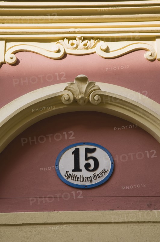 Vienna, Austria. Detail of pink and cream painted exterior facade with street number 15. Austria Austrian Republic Vienna Viennese Wien Europe European City Capital Architecture Building Facade Exterior Number Street Detail pinkl Cream Paint Painted Color Destination Destinations Osterreich Viena Western Europe