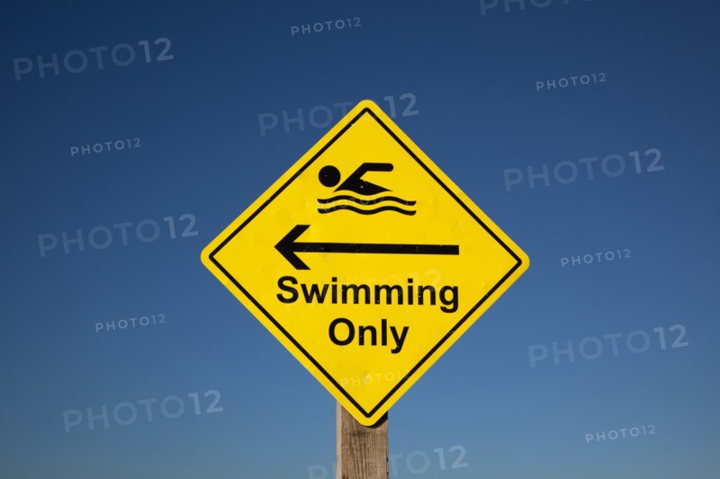 Sign indicating stretch of beach suitable for safe swimming. Sign Signs Information Warn Warning Indicate Indicating Safe Safety Yellow Blue Sky Swim Swimming Swimmer Swimmers Show Showing Point Pointing Arrow Post Only