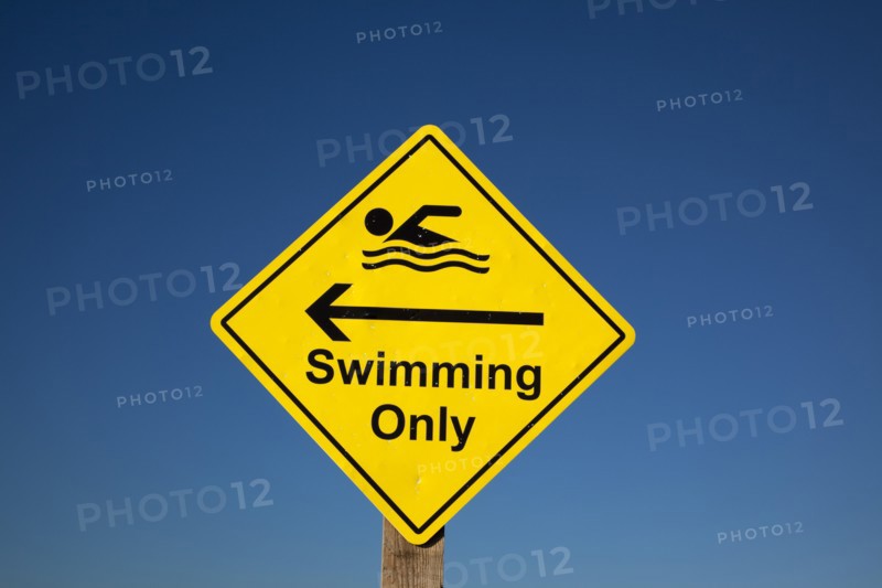 Shoreham-by-Sea, West Sussex, England. Sign indicating stretch of beach suitable for safe swimming. Sign Signs Information Warn Warning Indicate Indicating Safe Safety Yellow Blue Sky Swim Swimming Swimmer Swimmers Show Showing Point Pointing Arrow Post Only