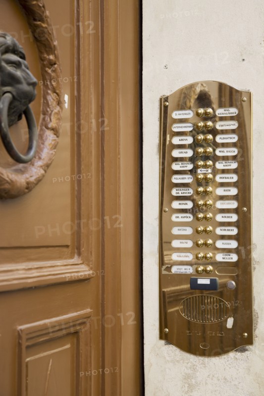 Vienna, Austria. Polished brass bell and names of residents at apartment entrance. Austria Austrian Republic Vienna Viennese Wien Europe European City Capital Architecture Building Entrance Door Bell Doorbell Bells Names Numbers Brass Panel Plate Speaker Entry Apartment Apartments Flat Flats Flat Osterreich Viena Western Europe