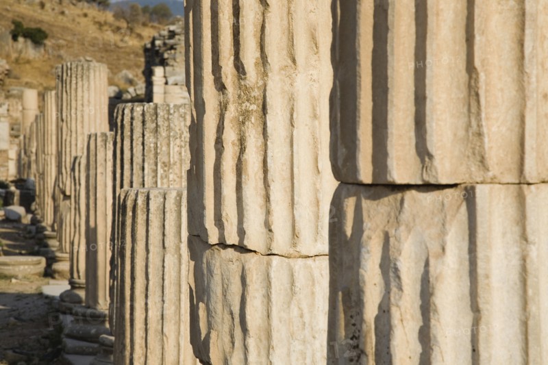 Selcuk, Izmir Province, Turkey. Ephesus. Line of broken columns in ancient city of Ephesus on the Aegean sea coast. Turkey Turkish Eurasia Eurasian Europe Asia Turkiye Izmir Province Selcuk Ephesus Ruin Ruins Roman Column Columns Facde Ancient Architecture Masonry Rock Stone Destination Destinations European History Historic Middle East South Eastern Europe Water Western Asia
