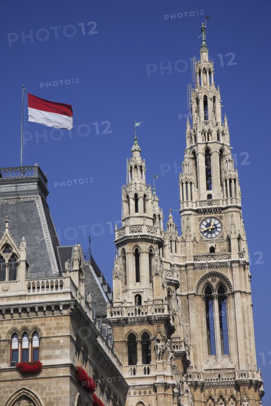Vienna, Austria. Rathaus detail of roof and towers with red and white flag flying. Austria Austrian Vienna Wien Viennese Republic Austro-Bavarian Wean Europe European City Capital Travel Destination Rathus Townhall Town Hall Roff Flag Blue Sky