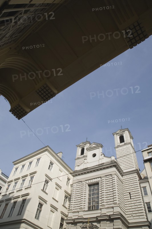 Vienna, Austria. Neubau District. Church exterior viewed from beneath awning of apartment building opposite. Austria Austrian Republic Vienna Viennese Wien Europe European City Capital neubau District Architecture Buildings Religious Christian Church Religion Christianity Exterior Facade Awning Blue Color Destination Destinations Flat Osterreich Religion Religious Christianity Christians Viena Western Europe