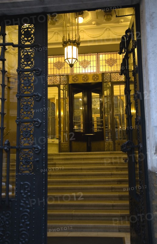 Budapest, Pest County, Hungary. Art Nouveau apartment building entrance. Hungarian Europe European East Eastern Buda Pest Budapest City Art Nouveau Apartment Building Entrance Hall Door Doorway Architecture Detail Steps Light Lamp Night Illuminated Ornate Destination Destinations Eastern Europe Flat Nite