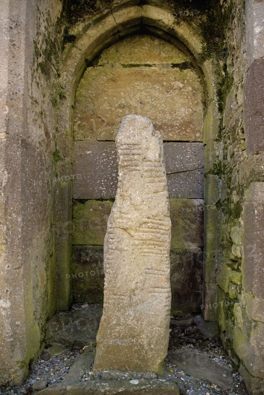 Ardmore, County Waterford, Ireland. Monastic Site Ogham Stone in the Cathedral. Ireland Irish Eire Erin Europe European County Waterford Adrmore Monastic Monastery Ruin Site Ogham Stone Cathedral Religion Religious Christian Christianity Destination Destinations History Historic Northern Europe Poblacht na hEireann Religion Religious Christianity Christians Republic