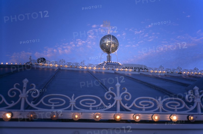 Brighton, East Sussex, England. Brighton Pier roof detail with mirrored ball and lights illuminated at night European Great Britain Nite Northern Europe UK United Kingdom