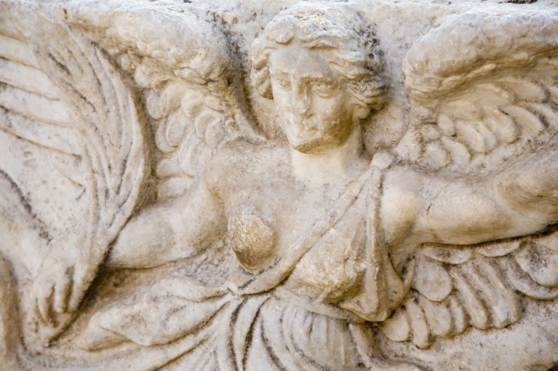 Selcuk, Izmir Province, Turkey. Ephesus. Detail of bas relief carving of the Goddess Nike on column in the antique city of Ephesus on the Aegean sea coast. Asian Destination Destinations European History Historic Middle East South Eastern Europe Turkish Turkiye Water Western Asia