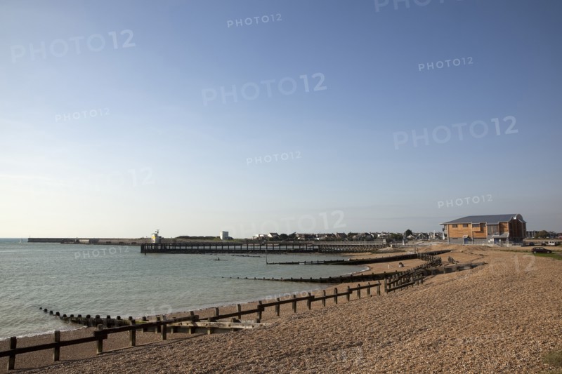 Shoreham-by-Sea, West Sussex, England. Kingston Beach Newly constructed lifeboat house opposite the harbour entrance. England English West Sussex County Shoreham Shoreham-by-Sea by Sea Water Kingston Beach Europe European Architecture Modern Life Boat Lifeboat Lifeboats RNLI Wood Wooden Clad Galvanised Metal Zinc Blue Sky Station Home Timber Frame Groynes Breaks