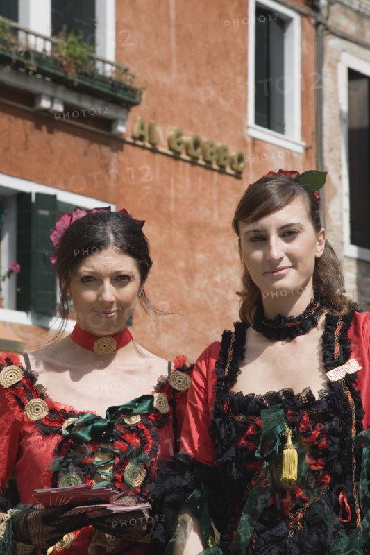 Venice, Veneto, Italy. Portrait of two young women wearing traditional costume to promote Venice Casino. Italy Italia Italian Venice Veneto Venezia Europe European City Women Woman Girl Girls Female Traditional Dress Costume 2 Classic Classical Destination Destinations Female Woman Girl Lady Female Women Girl Lady Historical Immature Older Southern Europe