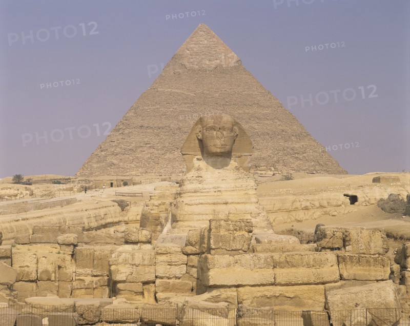 Giza, Cairo Area, Egypt. Pyramid and the Sphinx. Egypt Egyptian Africa African Cairo Giza Pyramids Pyramid Sphinx Desert Ancient Sand History Culture Old Stone Yellow Statue Sculpture Blue Cultural Cultures Destination Destinations History Historic Middle East North Africa