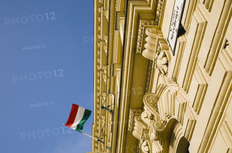 Budapest, Pest County, Hungary. Renovated facade on Pest bank of Danube with Hungarian flag. Hungary Hungarian Europe European East Eastern Buda Pest Budapest City Architecture Flag Tricolor Tricolour Green Red Red Detail Blue Sky Destination Destinations Eastern Europe