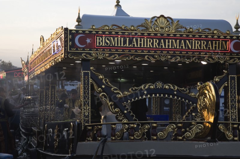 Istanbul, Turkey. Sultanahmet. Traditional fish restaurant boat on the Golden Horn adjacent to Galata with highly decorative black and gold detail to structure. Turkey Turkish Istanbul Constantinople Stamboul Stambul City Europe European Asia Asian East West Urban Destination Travel Tourism Sultanahmet Bosphorous Galata Bridge Cafe Restaurant Floating Boat Ship Golden Hind Fish Food Tradtitional Bar Bistro Classic Classical Color Destination Destinations Historical Middle East Older South Eastern Europe Turkiye Western Asia