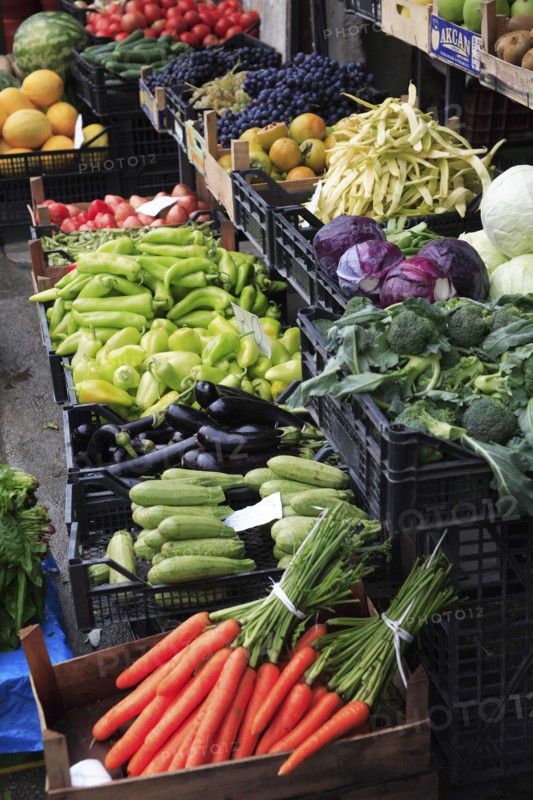 Albania, Tirane, Tirana, Grocers fruit and vegetable shop front in the Avni Rustemi market with display including grapes  cabbage  peppers  aubergine and carrots.