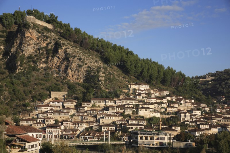 Albania, Berat, Traditional Ottoman buildings on hillside above footbridge over the River Osum.