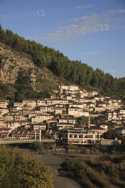 Albania, Berat, Traditional Ottoman buildings on hillside above footbridge over the River Osum.