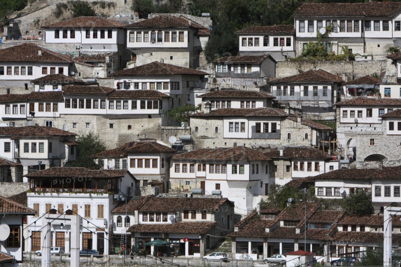 Albania, Berat, Ottoman houses in the old town with white painted exteriors and tiled roof tops.