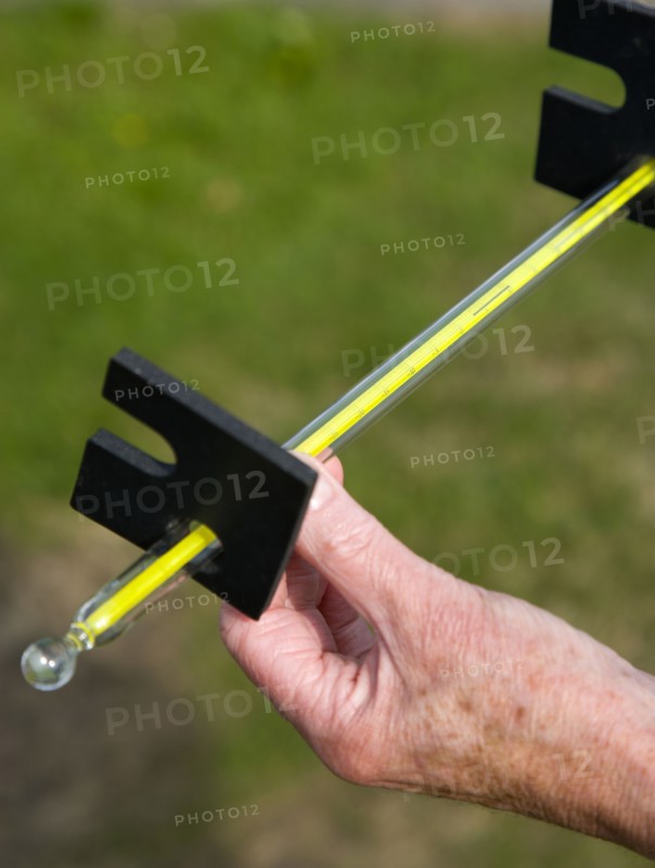 Climate, Weather, Measurements, Weather observer reading the thermometer that measures grass temperature during the night at Bognor Regis weather station.
