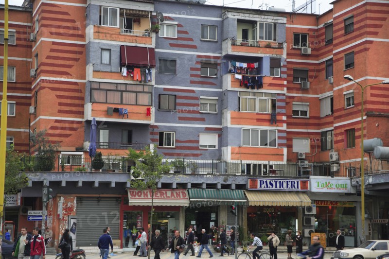 Albania, Tirane, Tirana, Colourful apartment buildings with shops below.
