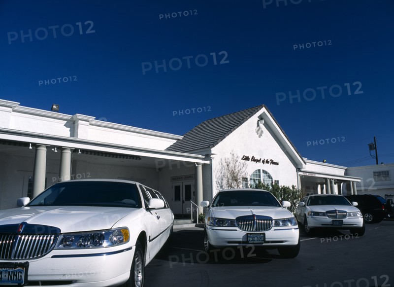 USA, Nevada, Las Vegas, Little Chapel of the Flowers  Wedding Chapel with three white limousines outside.